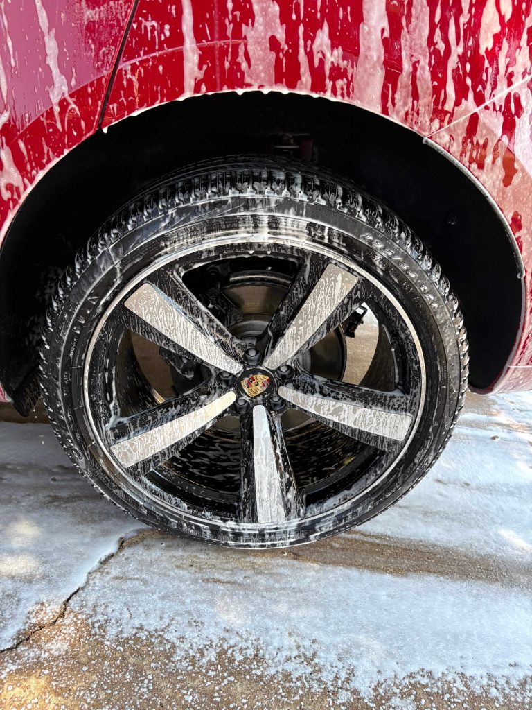 Foam-covered wheel and tire cleaning during mobile car wash service by Luna Car Wash & Detailing in DFW